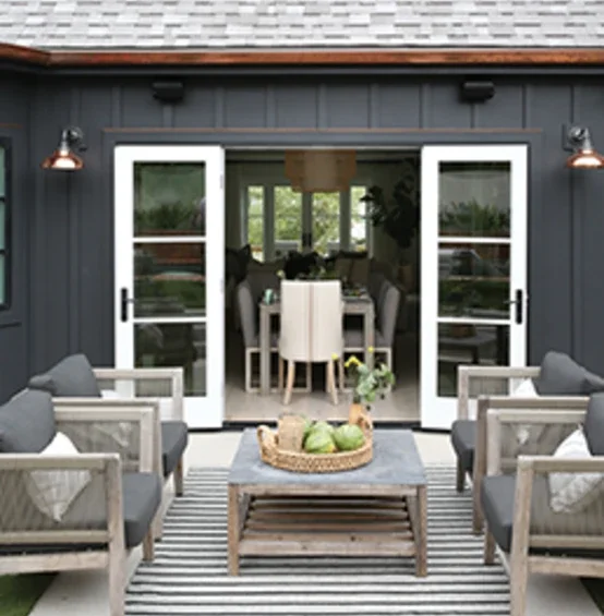Exterior of home facing outswing patio doors leading into inside of home