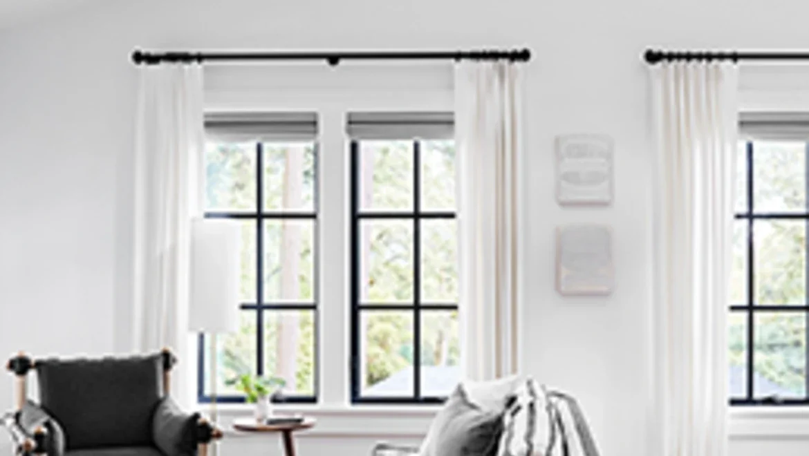 Living room facing C650 Ultra Series black casement windows with colonial grid pattern