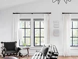 Living room facing C650 Ultra Series black casement windows with colonial grid pattern