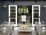 Exterior of home facing outswing patio doors leading into inside of home