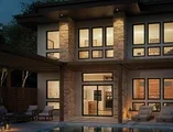 Two story home at dusk. You can see the lights in the house are on with black V300 windows and doors.