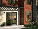 Exterior of home showing detailed door and black windows 