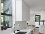 Modern white kitchen with black awning window