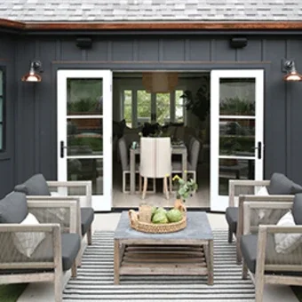 Exterior of home facing outswing patio doors leading into inside of home