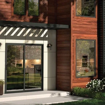 Exterior of home showing detailed door and black windows 