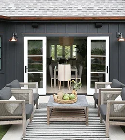 Exterior of home facing outswing patio doors leading into inside of home
