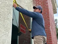 Milgard Installation with man measuring window with tape measure