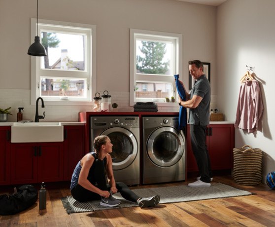 Two people in a laundry room.