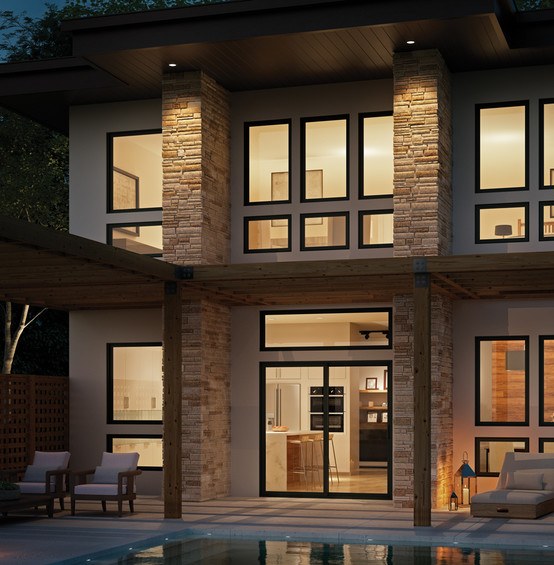 Two story home at dusk. You can see the lights in the house are on with black V300 windows and doors.