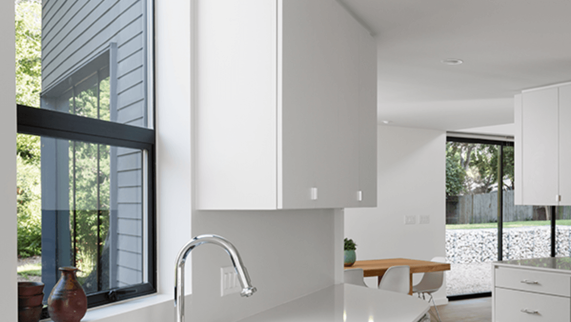 Modern white kitchen with black awning window