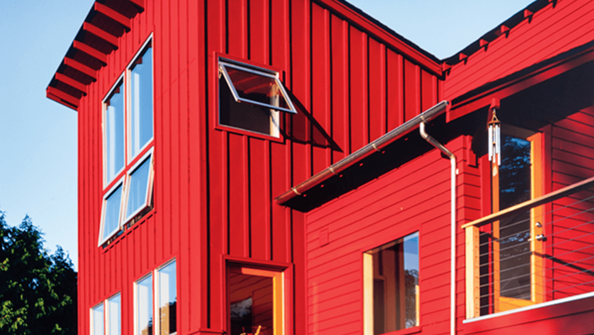 Exterior farmhouse style house with awning windows