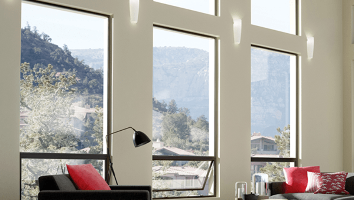 Modern living room facing towards aluminum picture and awning window combintations