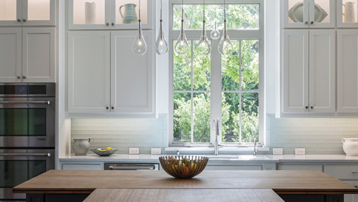 White Kitchen with wooden countertops and white casement window