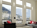 Modern living room facing towards aluminum picture and awning window combintations