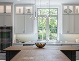 White Kitchen with wooden countertops and white casement window