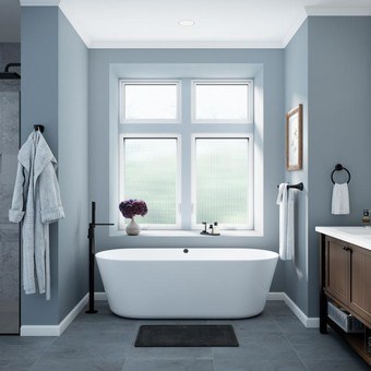 Bathroom facing large tub with white casement windows with privacy glass 