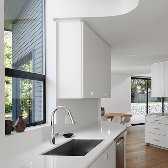 Modern white kitchen with black awning window