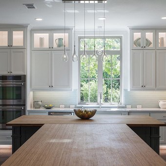White Kitchen with wooden countertops and white casement window