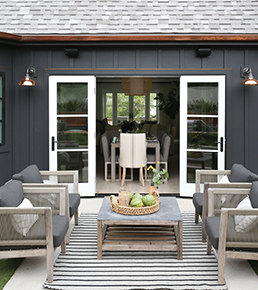 Exterior of home facing outswing patio doors leading into inside of home