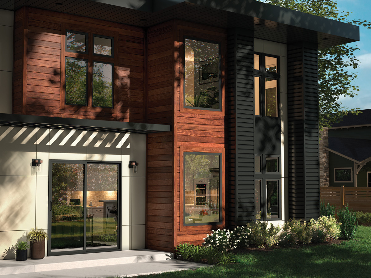 Exterior of home showing detailed door and black windows 