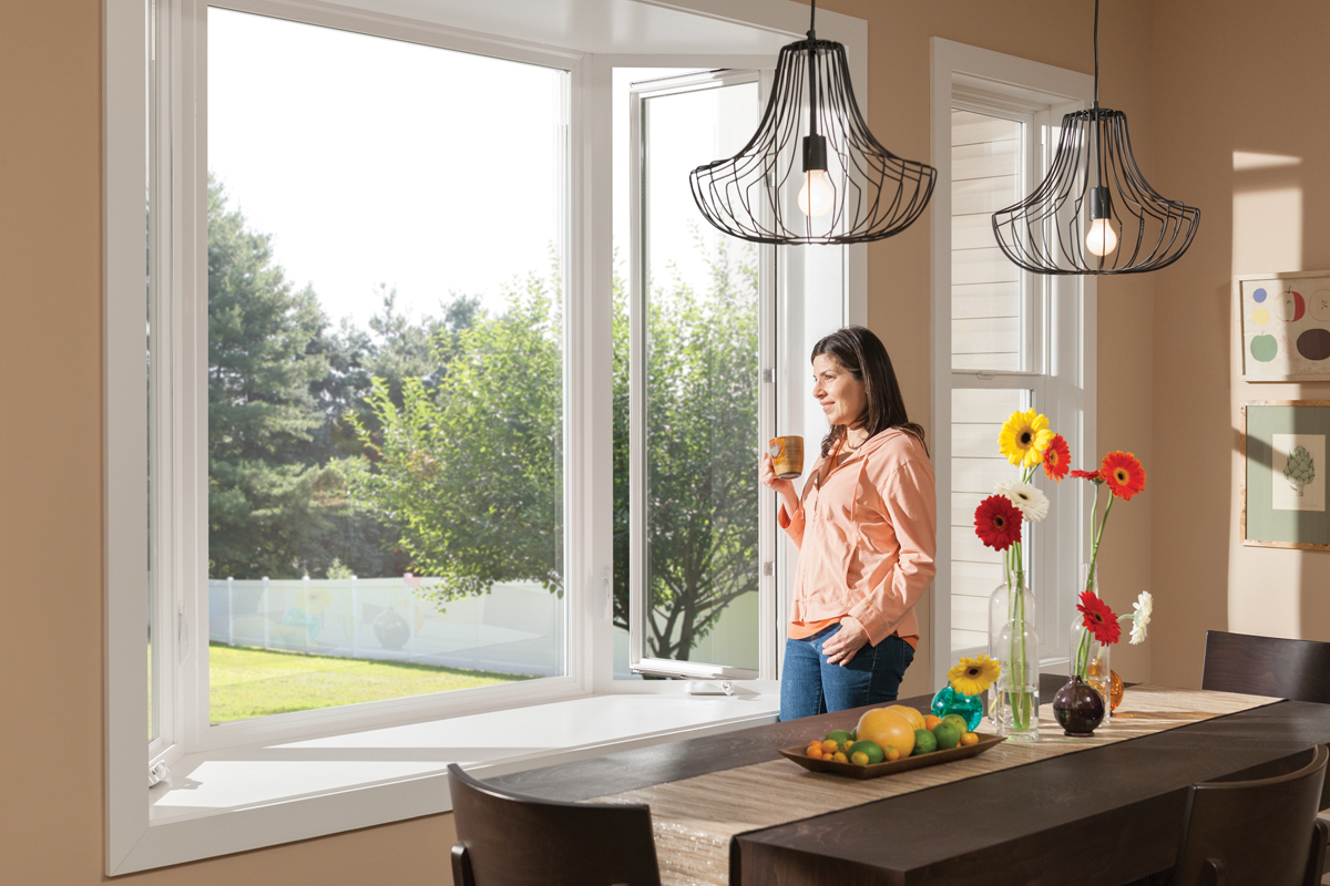 Tuscany® Series | V400 White Bay Window with woman looking outside from inside home