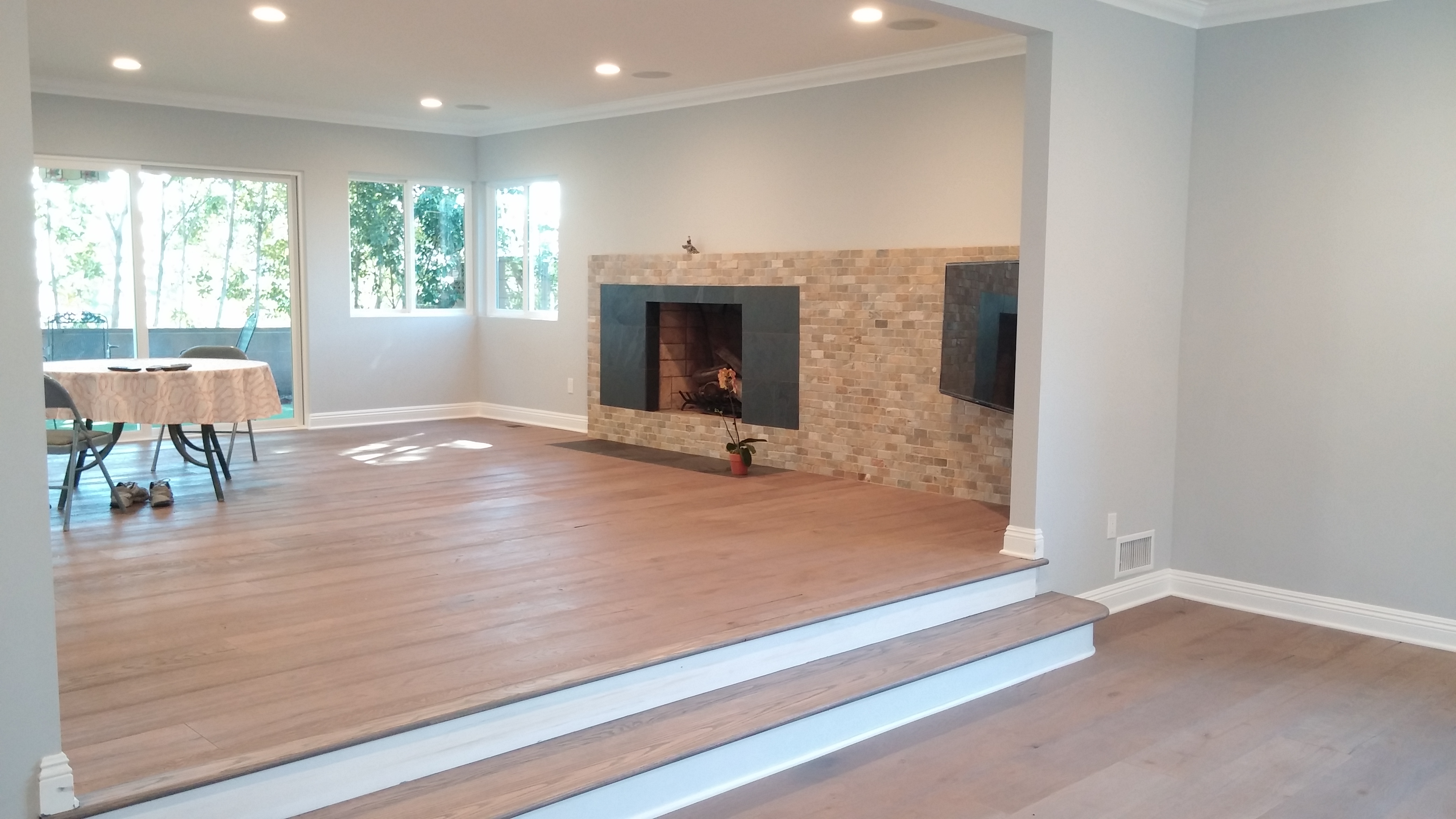 Fireplace with horizontal slider and bay window in front room