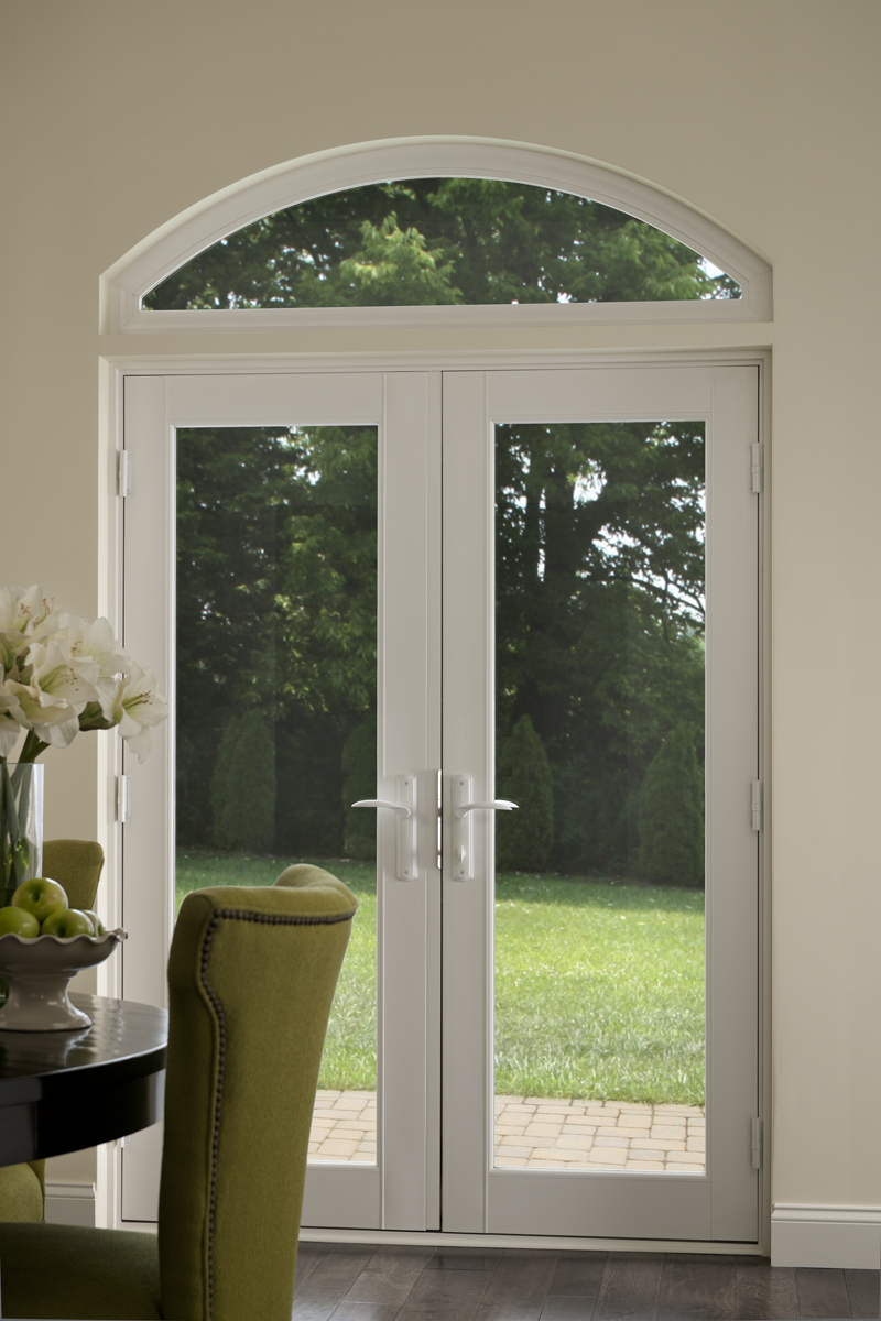 A Tuscany Series In-swing patio door with a transom window attached.
